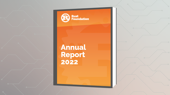 Annual Report Graphic of a book with the title reading "Rust Foundation Annual Report 2022" against a grey gradient geometric background.